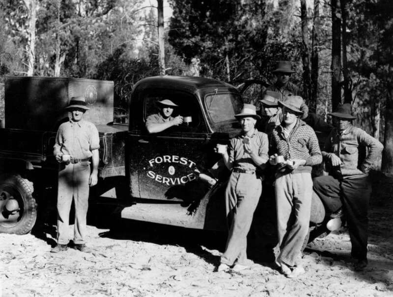 Image of members of the Forest Service enjoy a tea break by the side of the road.