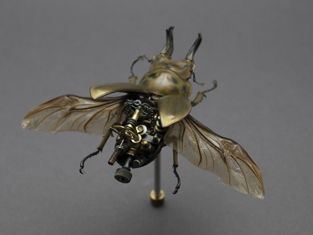 Image of a gold bug sculpture.