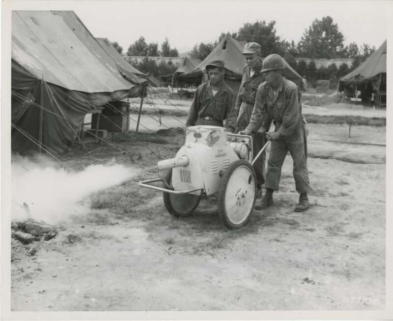Sergeant James H. Johnson, Pittsburg, MS (right) instructs Sergeant 1st Class Jack Frederick, Wellsville, IL (center) and Sergeant Teddy Sadlocha, Hamtramck, MI (left), members of Medical Detachment, United States IX [9] Corps, in the use of the DDT sprayer. Korean War. 8/15/1951 Otis Historical Archives of the National Museum of Health and Medicine, in Washington DC.
