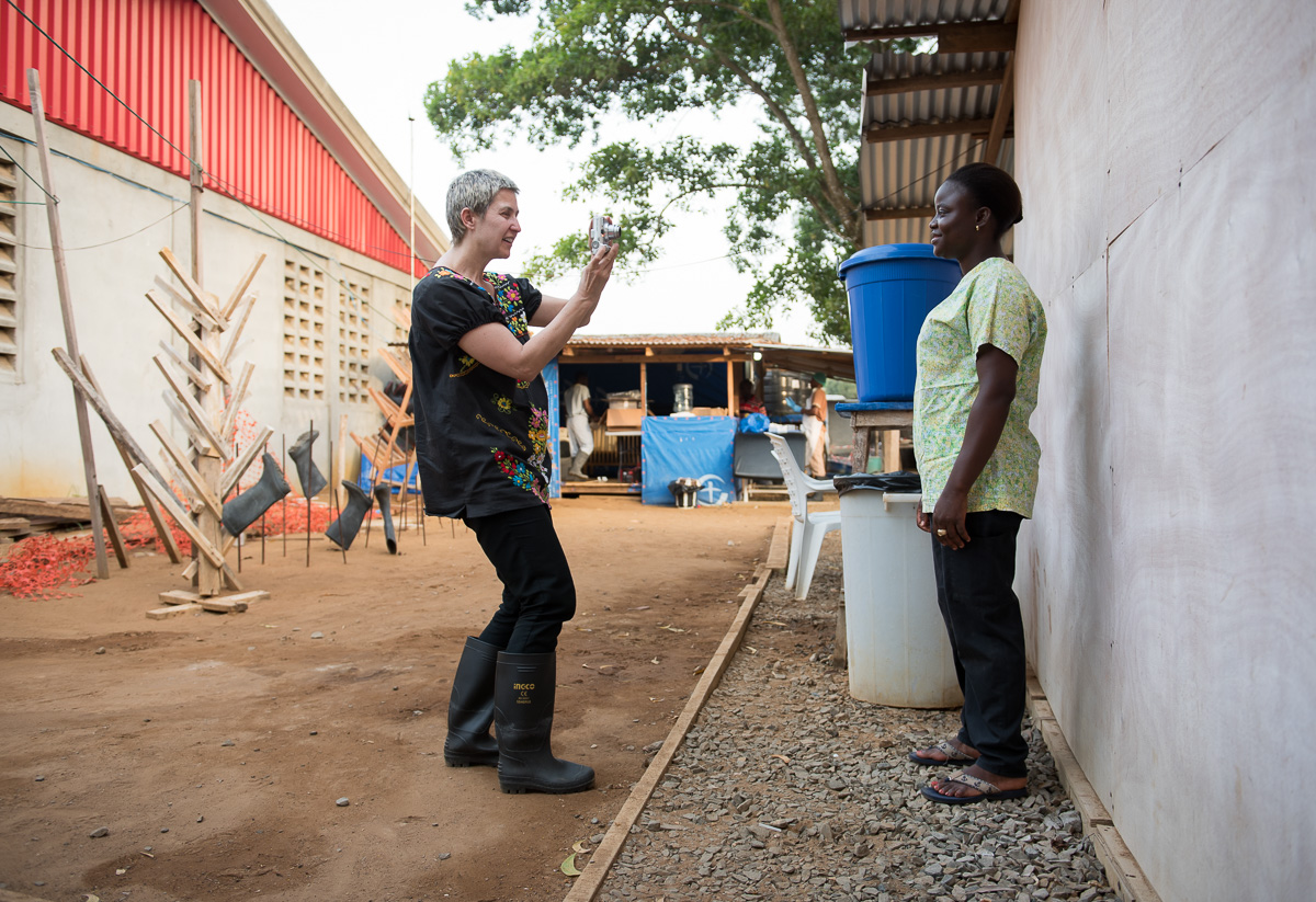 Occidental College professor Mary Beth Heffernan photographs health care worker Roseline Biego, R.N. at ELWA II ETU (Ebola treatment unit) in Monrovia, Liberia on Sunday, March 1, 2015. The photos will be used in Professor Heffernan’s PPE Portrait Project. (Photo by Marc Campos, Occidental