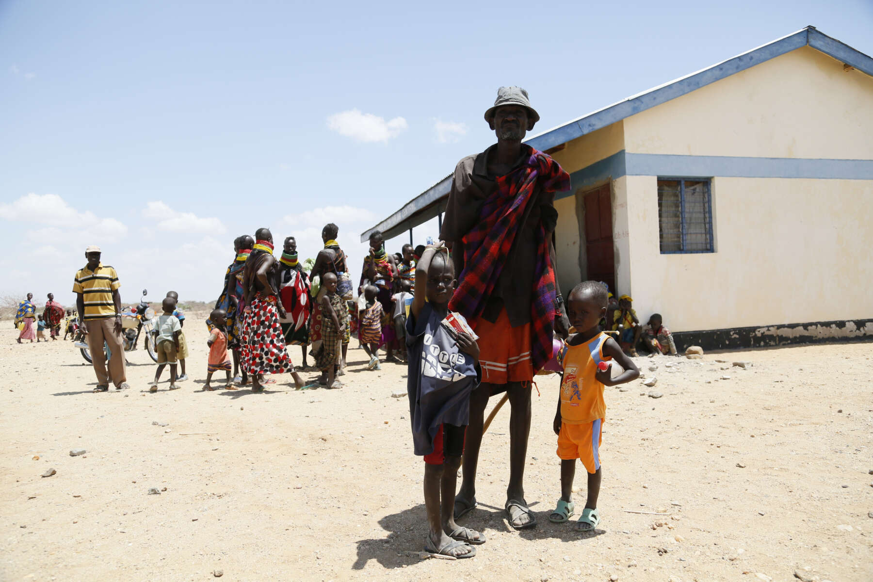 Ngikadelio Ngikeny (left) and his father Lokongto pictured outside a health clinic in Turkana County, northwest Kenya, 29 March 2017. Ngikadelio was identified by International Rescue Committee staff as suffering from Severe Acute Malnutrition