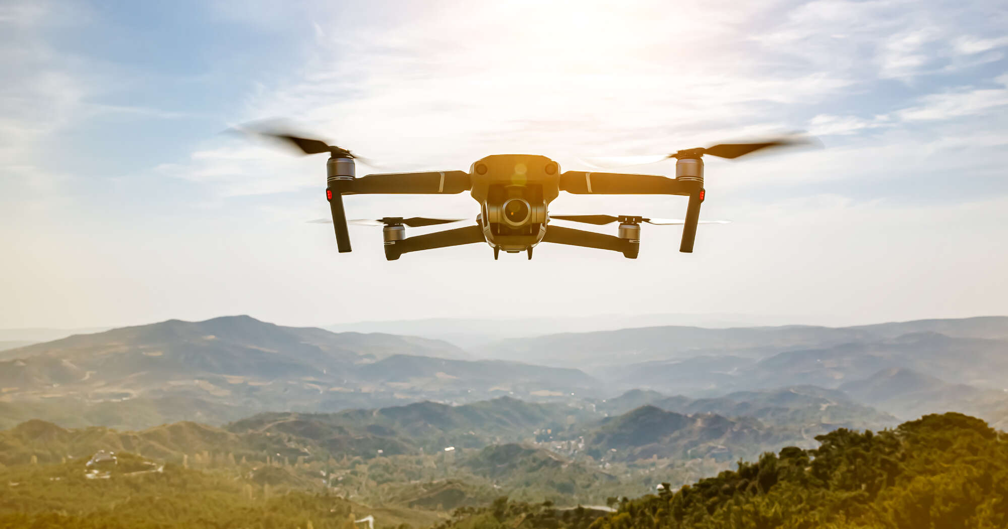 Image of a drone flying over nature.