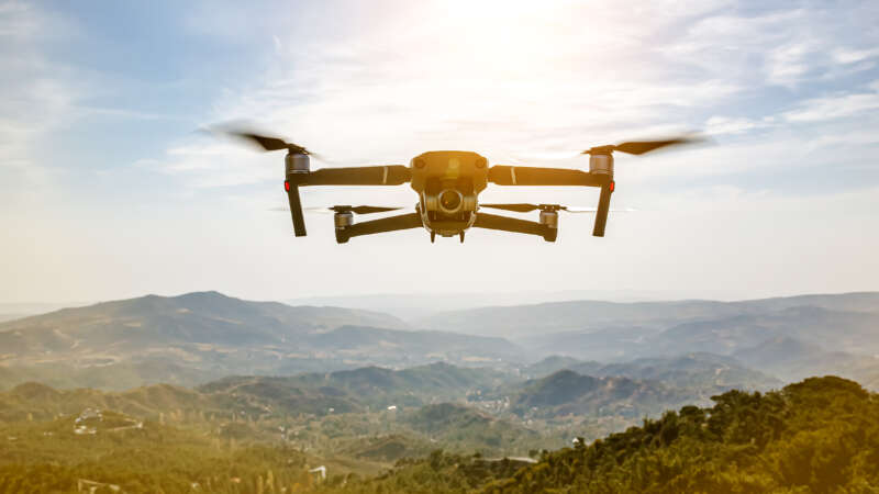 Image of a drone flying over nature.