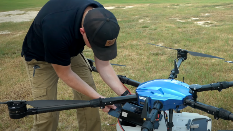 Image of a pilot with spray drone